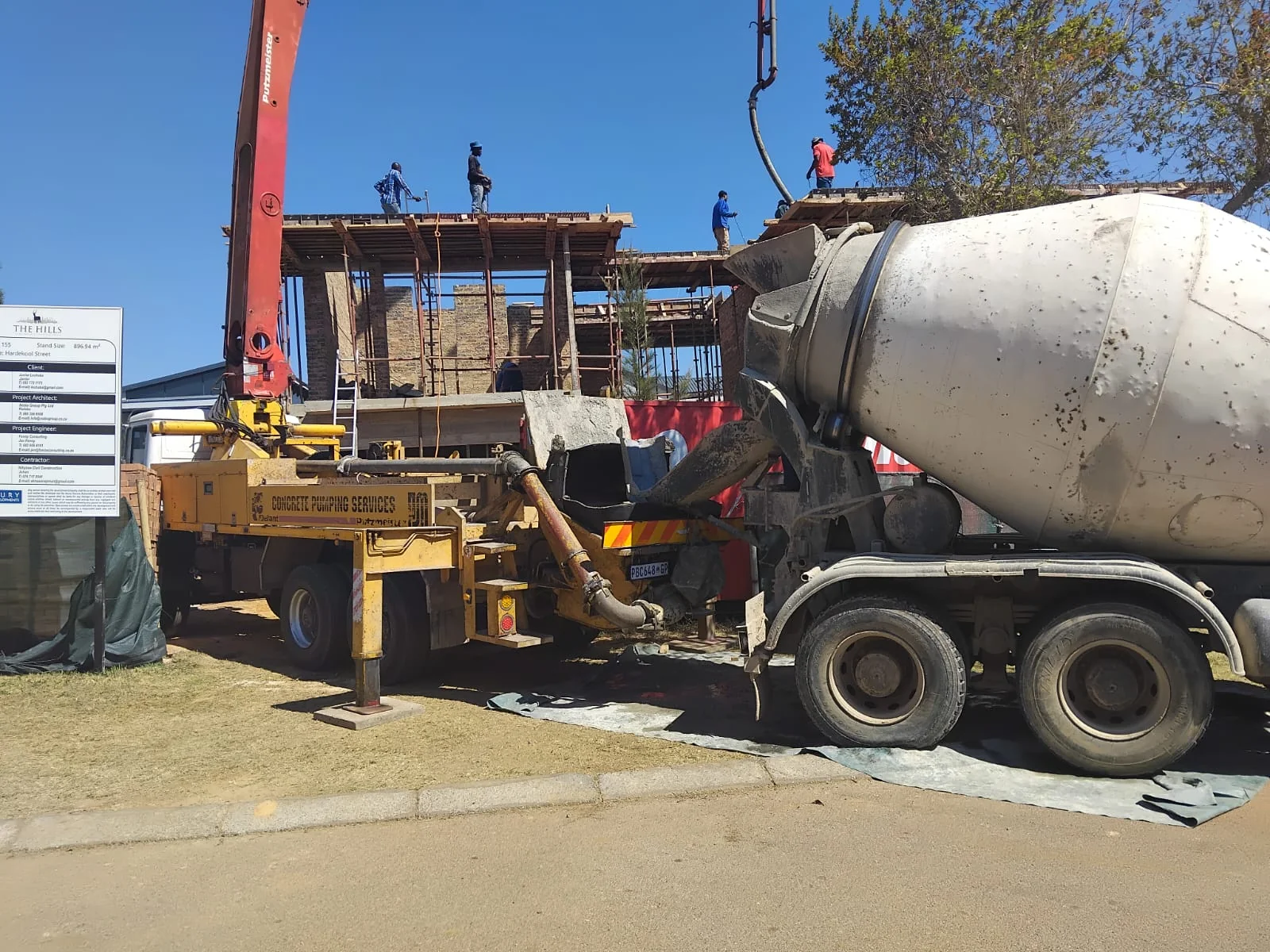 Active construction site with workers and heavy machinery